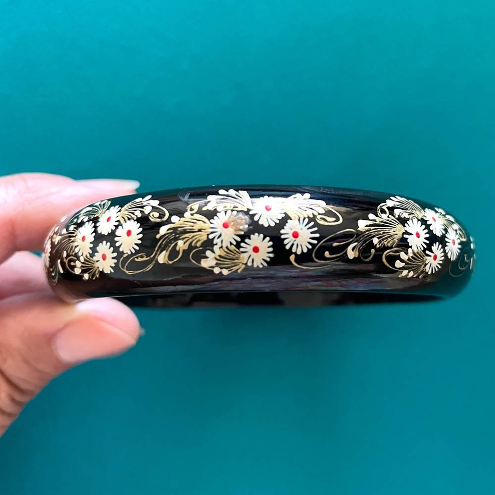 Black lacquered bangle bracelet. Always a fun accent piece for your ward…
